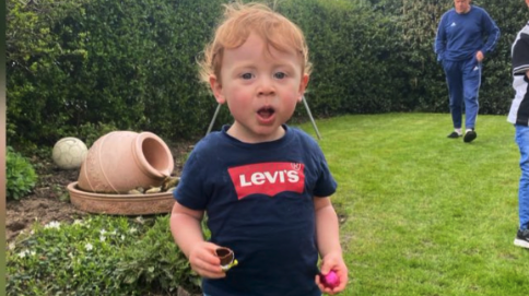 Toddler Teddie seen holding Easter eggs during the hunt. 