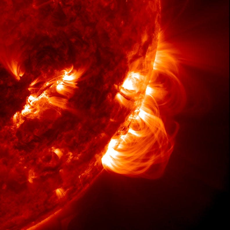 Hybrid image of solar prominances and the solar chromosphere from NASA satellite images. Chromosphere literally means “sphere of color” and is the second of the Sun’s three main layers. Temperatures in the chromosphere range from 6,700 degrees F near the surface and rise up to 14,000 degrees F at the top. The chromosphere appears red because of the large amount of hydrogen present. The most visible and impressive features of the chromosphere include prominences. These gigantic plumes of gas are trapped by magnetic fields, reaching altitudes of 93,000 miles above the Sun.
