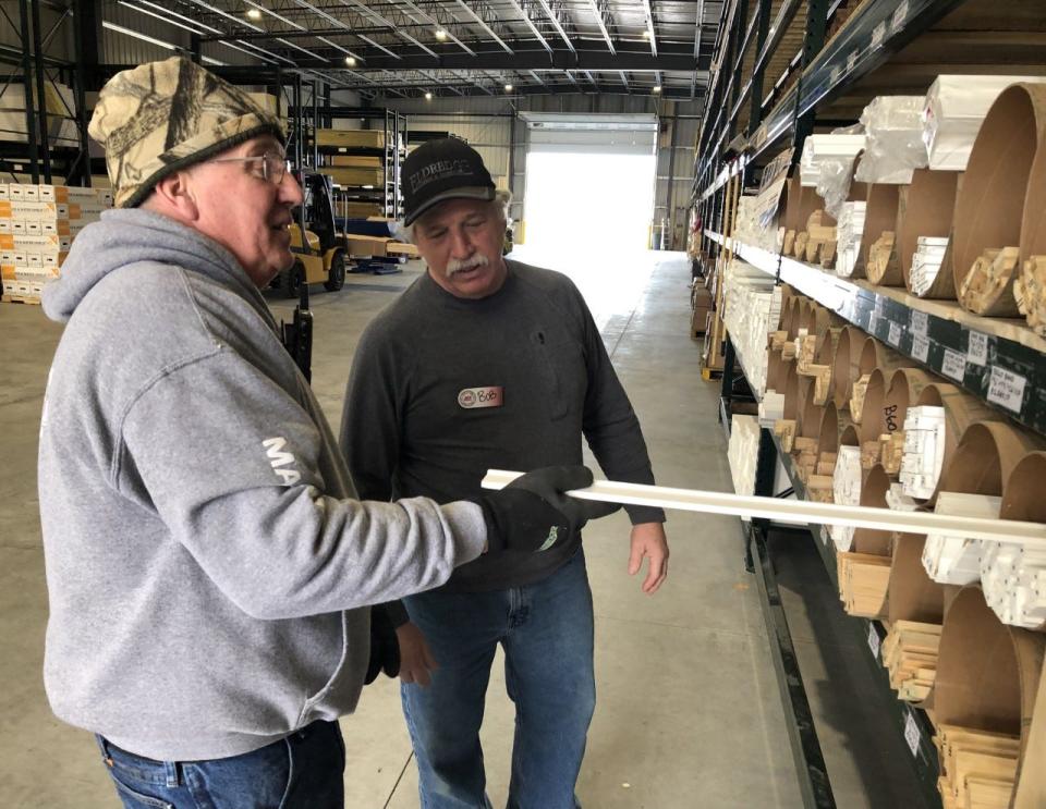 John Savoie, left, and Bob D'Angelo, of Eldredge Lumber and Hardware, are seen here in the lumber storage facility at the new Eldredge Lumber and Hardware store on Route 109 in South Sanford, Maine, on Monday, March 27, 2023.