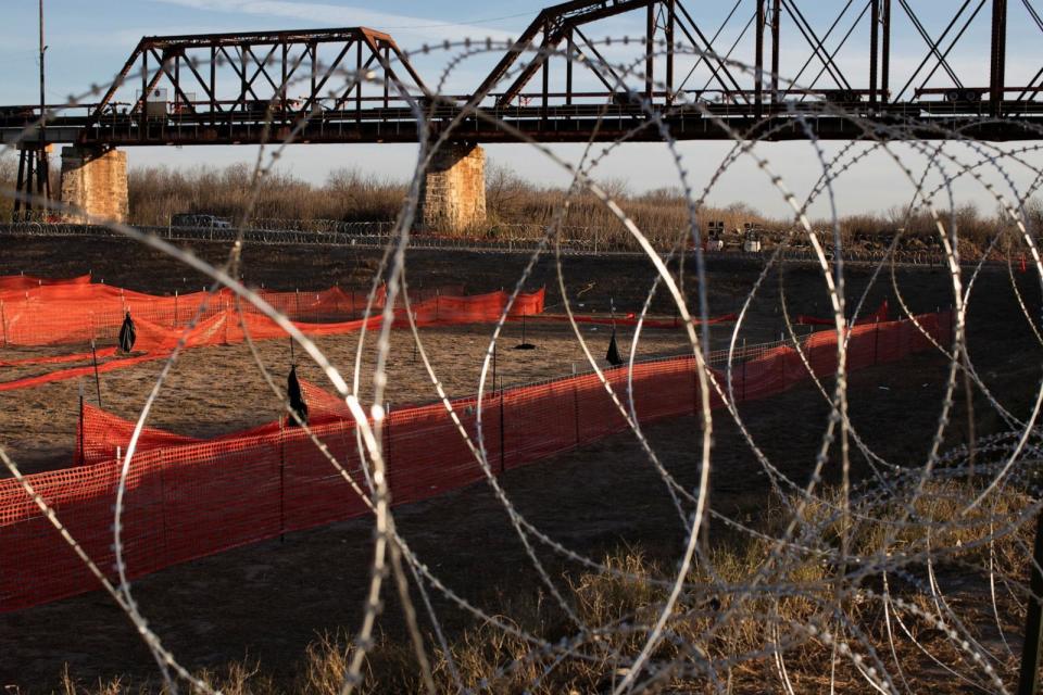 PHOTO: Concertina wire, placed by the Texas National Guard, is set up around the perimeter of a pit previously used to hold migrants in Shelby Park, at the U.S.-Mexico border in Eagle Pass, TX Jan. 16, 2024. (Kaylee Greenlee Beal/Reuters)
