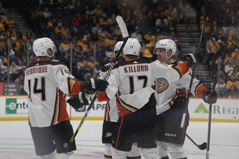 Anaheim Ducks teammates congratulate defenseman Urho Vaakanainen, right, after a goal against the Nashville Predators during the third period of an NHL hockey game Tuesday, Nov. 14, 2023, in Nashville, Tenn. (AP Photo/George Walker IV)