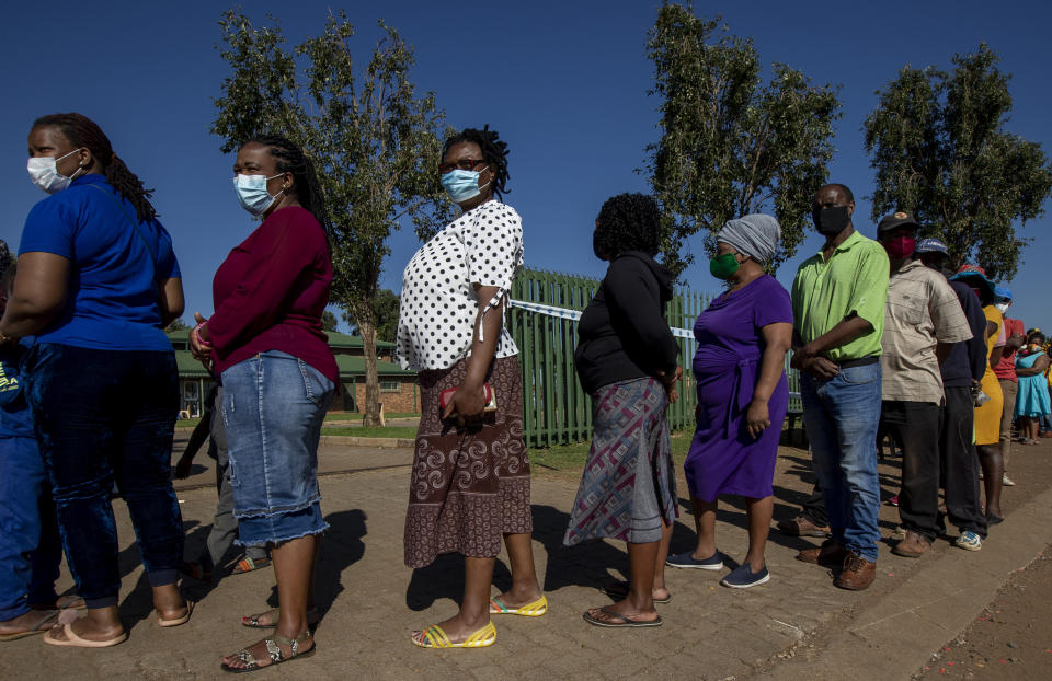 People queue outside a polling station in Thokoza, east of Johannesburg, Monday, Nov. 1, 2021. South Africa is holding crucial local elections Monday. (AP Photo/Themba Hadebe)