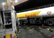 FILE PHOTO: Oil tank truck fills the pumps at a Shell petrol station in Sao Paulo