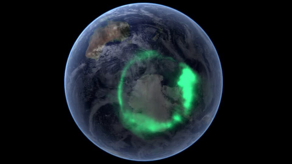  A green aurora rings part of the globe. 