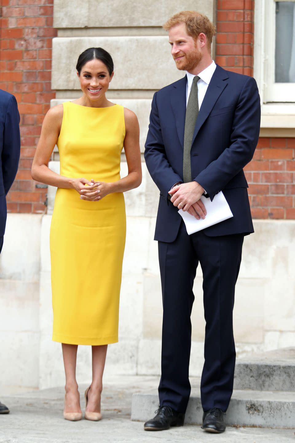 <p>Meghan Markle opted for a sleeveless yellow Brandon Maxwell midi dress for a Commonwealth Youth event, which had a boat neck reminiscent of her Givenchy wedding dress. </p>