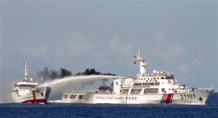 A Chinese ship (R) uses water cannon on a Vietnamese Sea Guard ship on the South China Sea near the Paracels islands, in this handout photo taken on May 3, 2014 and released by the Vietnamese Marine Guard on May 8, 2014. REUTERS/Vietnam Marine Guard/Handout via Reuters