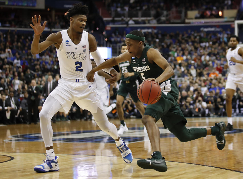 Michigan State guard Cassius Winston (5) drives past Duke forward Cam Reddish (2) during the first half of an NCAA men's East Regional final college basketball game in Washington, Sunday, March 31, 2019. (AP Photo/Alex Brandon)