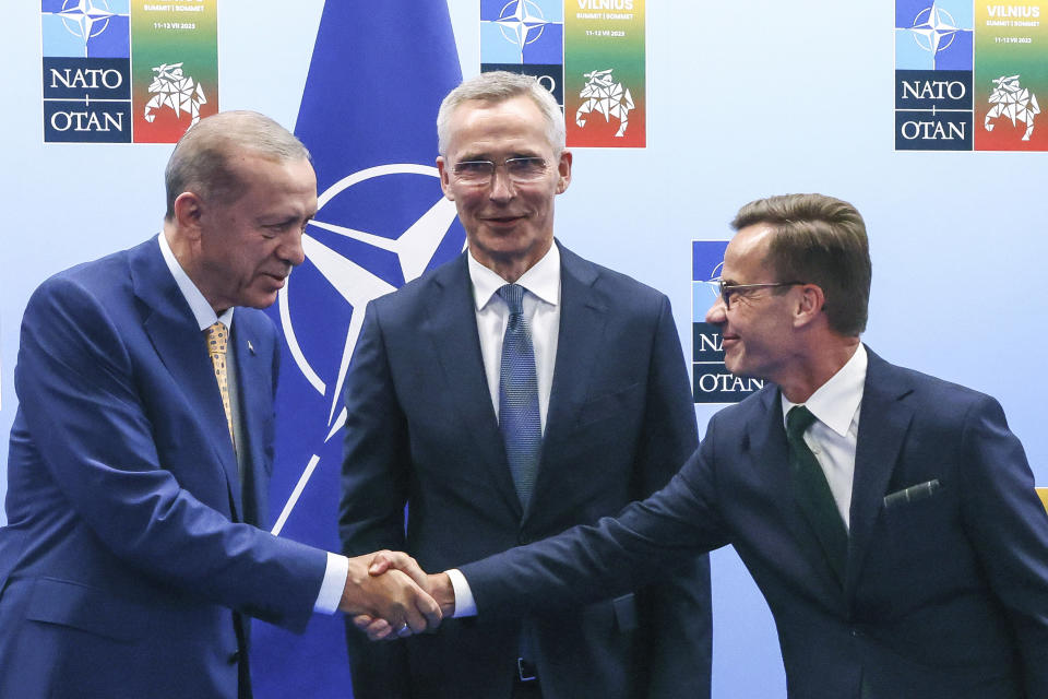 FILE - Turkey's President Recep Tayyip Erdogan, left, shakes hands with Sweden's Prime Minister Ulf Kristersson, right, as NATO Secretary General Jens Stoltenberg looks on prior to a meeting ahead of a NATO summit in Vilnius, Lithuania, Monday, July 10, 2023. The road for Sweden’s NATO membership has been bumpy, chiefly because of Turkey stalling ratifying Sweden’s application. (Yves Herman, Pool Photo via AP, File)