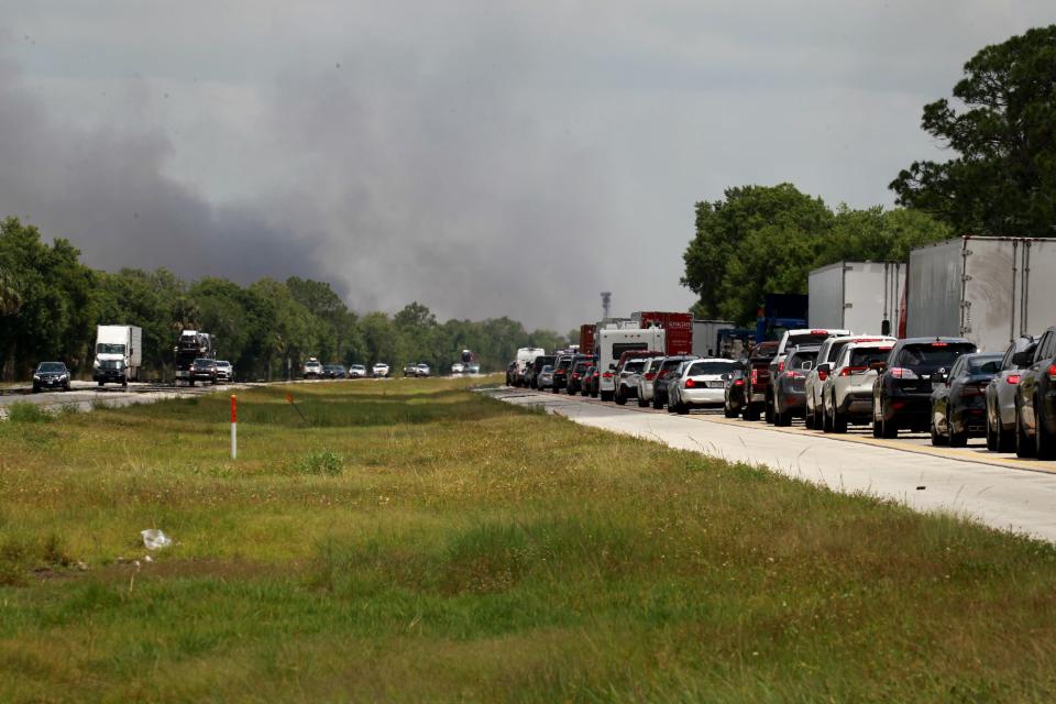 Northbound traffic is seen stalled along Interstate 95 which is closed in northern Indian River County and southern Brevard County all day on Friday, May 21, 2021, because of a wildfire at St. Sebastian River Preserve State Park. Vehicles are seen backed up on I-95 at mile marker 153. 