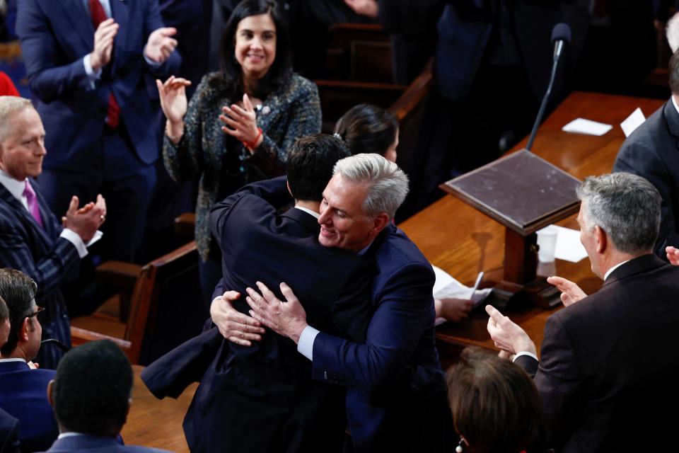 U.S. House Republican Leader Kevin McCarthy (R-CA) hugs his Floor Director John Leganski as he celebrates being elected the next Speaker of the U.S. House of Representatives while Republican Conference Chair Elise Stefanik (R-NY) applauds in a late night 15th round of voting on the fourth session of the 118th Congress at the U.S. Capitol in Washington, U.S., January 7, 2023. REUTERS/Evelyn Hockstein