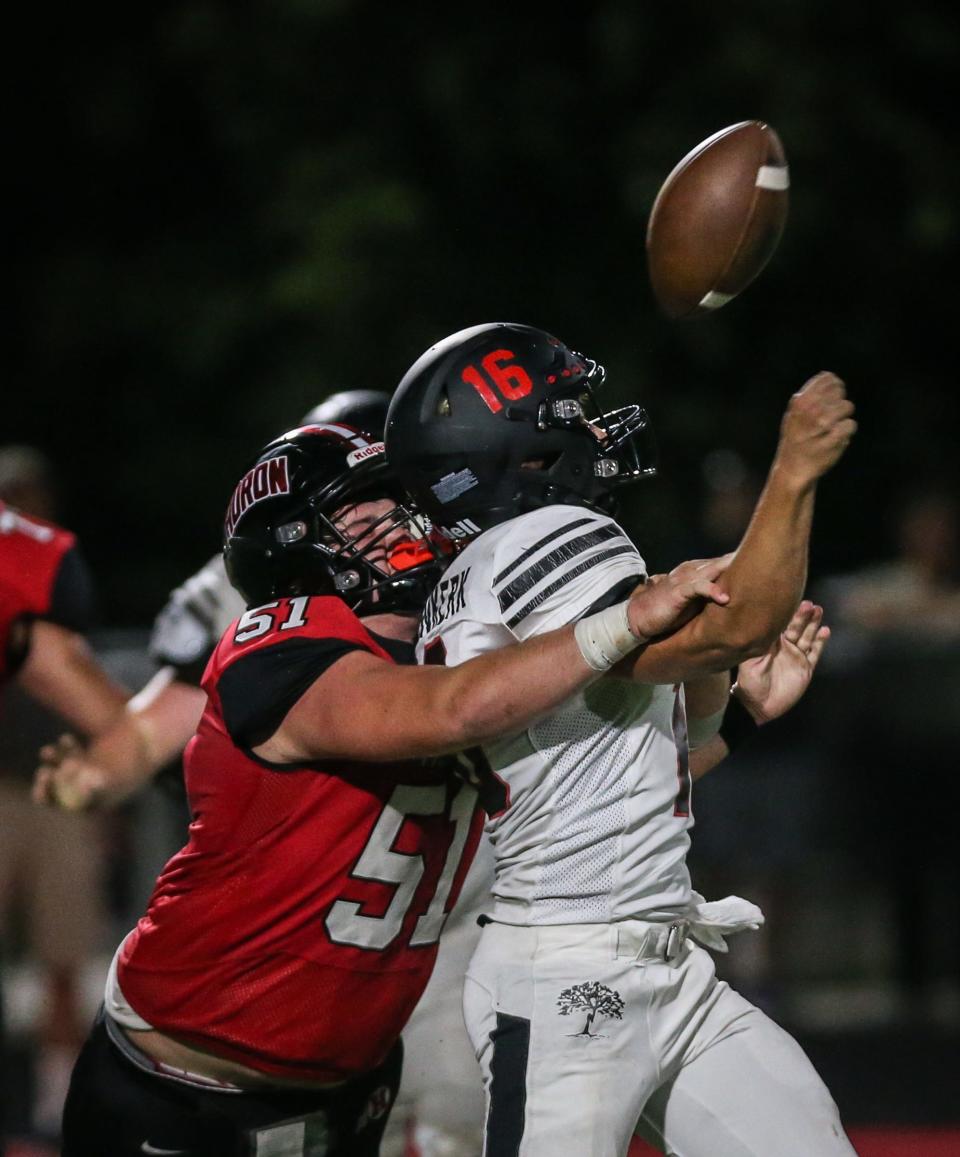New Boston Huron's Joshua Buettner (51) disrupts Milan's Brady Bovenkerk's pass on the final play of the game Thursday, Sept. 1, 2022. The pass was intercepted by Micah Smith and the game ended with a win for Huron 13-12.