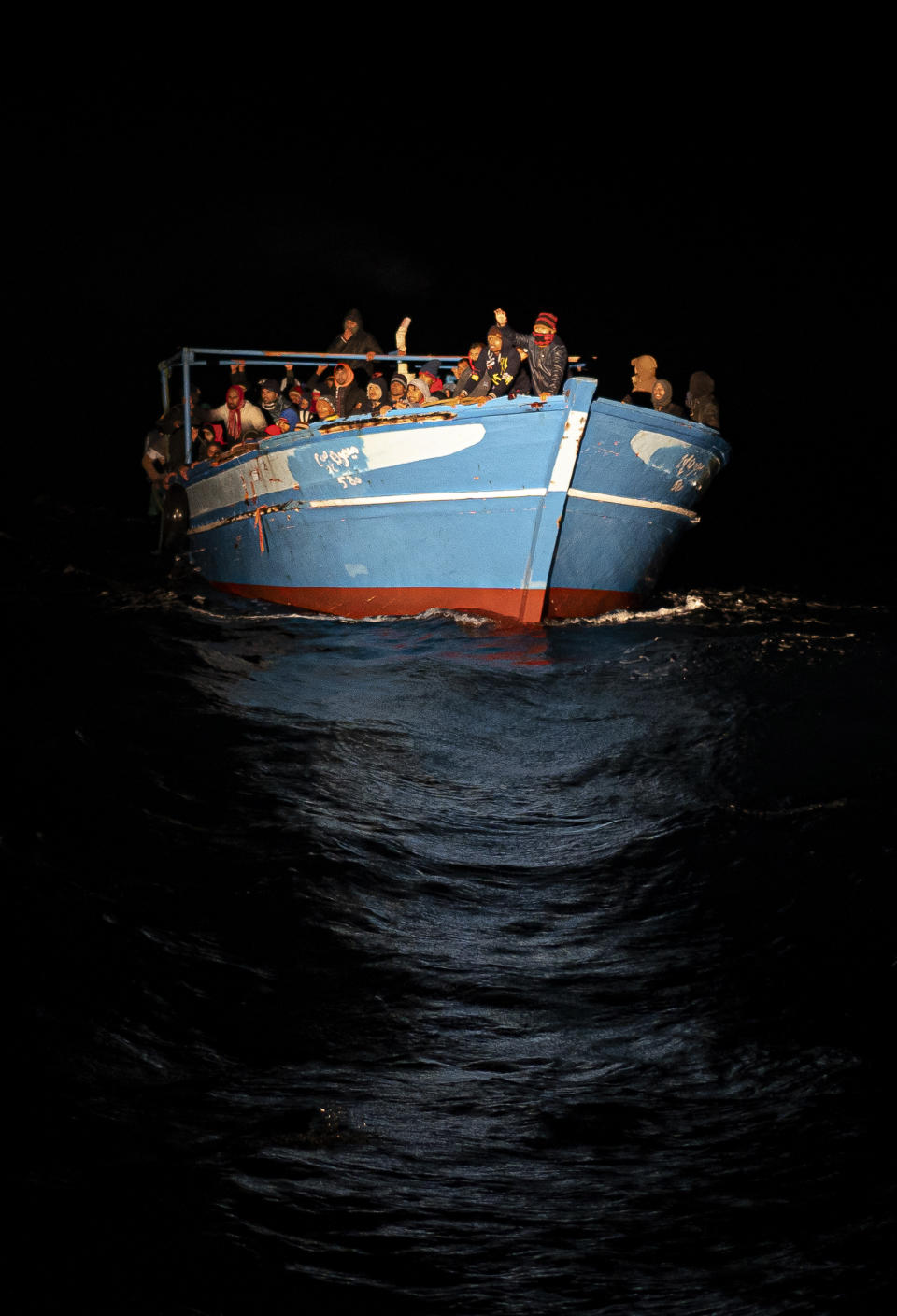 Migrants wait to be rescued off the coast of Lampedusa, Italy, on Monday Jan. 24, 2022. Seven migrants have died and some 280 have been rescued by the Italian Coast Guard after they were discovered in a packed wooden boat off the coast of the Italian island of Lampedusa. (AP Photo/Pau de la Calle)