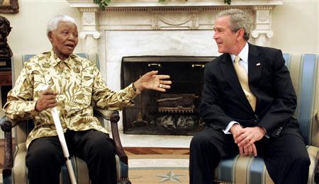 U.S. President George W. Bush meets with former South African president Nelson Mandela (L) in the Oval Office of the White House, in this file picture taken May 17, 2005. REUTERS/Kevin Lamarque/Files