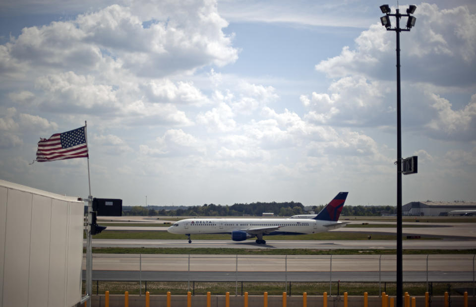 A plane passes a gate at the new Maynard Holbrook Jackson Jr. International Terminal at Atlanta's airport Wednesday, March 28, 2012. The new $1.4 billion international terminal at the world's busiest airport will be a sleek launching pad for millions of passengers that’s designed to help Atlanta grab a growing share of the lucrative market for global travelers. (AP Photo/David Goldman)