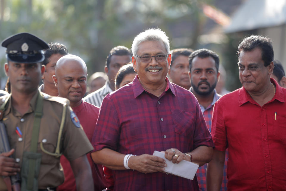 Sri Lanka's former Defense Secretary and presidential candidate Gotabaya Rajapaksa, center, leaves a polling station after casting his vote in Embuldeniya, on the outskirts of Colombo, Sri Lanka, Saturday, Nov. 16, 2019. Polls opened in Sri Lanka’s presidential election Saturday after weeks of campaigning that largely focused on national security and religious extremism in the backdrop of the deadly Islamic State-inspired suicide bomb attacks on Easter Sunday. (AP Photo/Eranga Jayawardena)