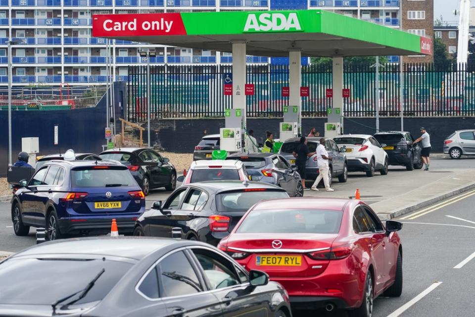 Cars queue for fuel at an Asda petrol station in south London (Dominic Lipinski/PA) (PA Wire)