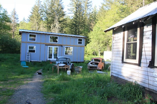 The “tiny mansion,” left, and cabin, right, where two families live (Alana Semuels / The Atlantic)