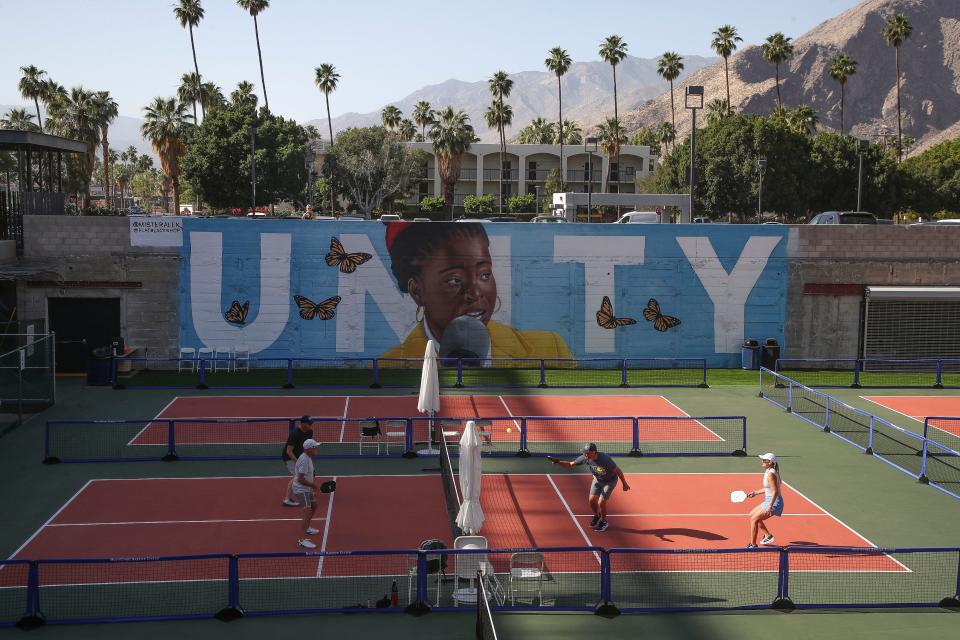 People play pickleball Thursday in downtown Palm Springs. Behind them is the mural "Unity," created by artist Mr. Alek and showing poet Amanda Gorman.
