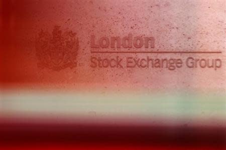 A red London bus passes the Stock Exchange in London February 9, 2011. REUTERS/Luke MacGregor