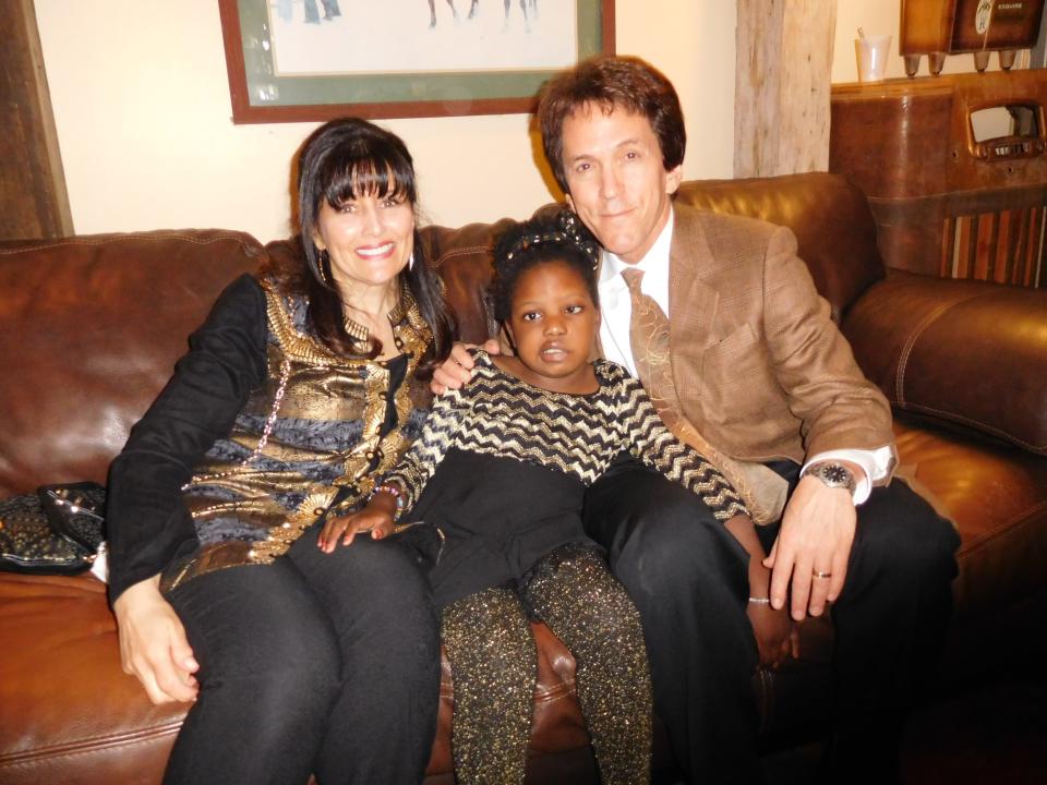 Author Mitch Albom and his wife, Janine, with their foster daughter Chika.