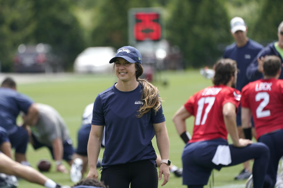 Amanda Ruller, who is currently working as an assistant running backs coach for the NFL football Seattle Seahawks through the league's Bill Walsh Diversity Fellowship program, works during NFL football practice on June 8, 2022, in Renton, Wash. Ruller's job is scheduled to run through the Seahawks' second preseason game in August. (AP Photo/Ted S. Warren)