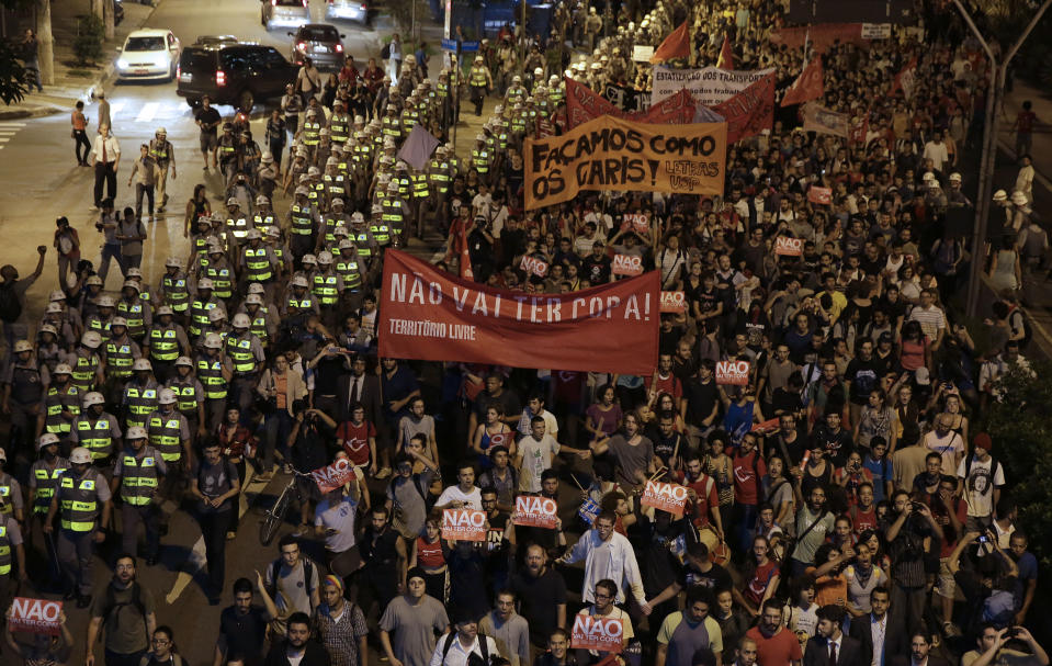 Demonstrators march holding a banner that reads in Portuguese "There wont be Cup", protest against money spent on the World Cup preparations in Sao Paulo, Brazil, Thursday, March 13, 2014. Thursday, Brazilian Sports Minister Aldo Rebelo guaranteed "the World Cup in Brazil will be the safest" in history even though widespread demonstrations are expected across the country to protest against corruption, poor public services and the billions of dollars being spent on the World Cup and 2016 Olympics in Rio de Janeiro. (AP Photo/Andre Penner)