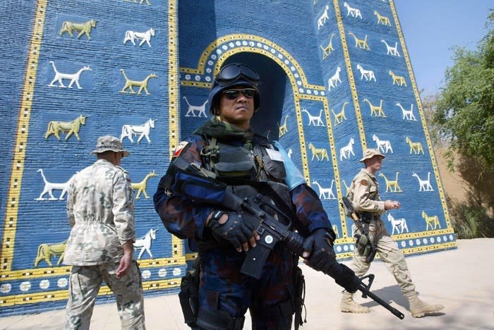 Soldiers near a replica of the Ishtar Gate in September 2003 (Thomas Coex / AFP / Getty)