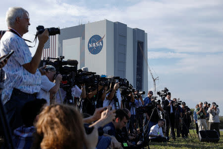 Members of the media attend a news conference before the launch of a SpaceX Falcon 9 carrying the Crew Dragon spacecraft on an uncrewed test flight to the International Space Station from the Kennedy Space Center in Cape Canaveral, Florida, U.S., March 1, 2019. REUTERS/Mike Blake