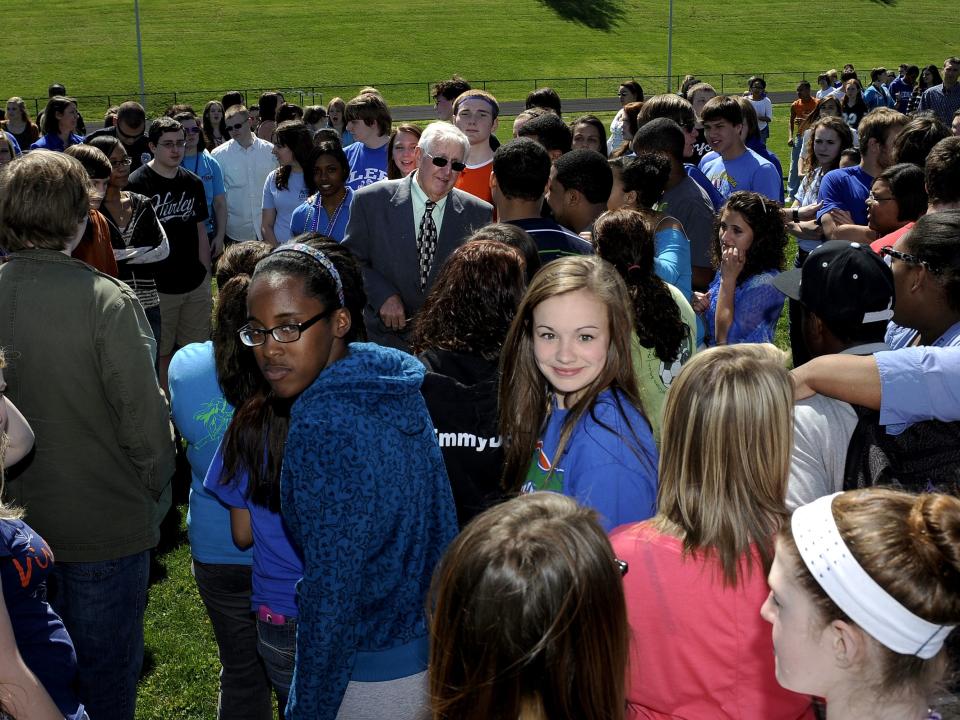 In a photo from 2012, when Edward Clymore was the interim superintendent of Staunton City Schools, high school students gather around him during a school-wide event.