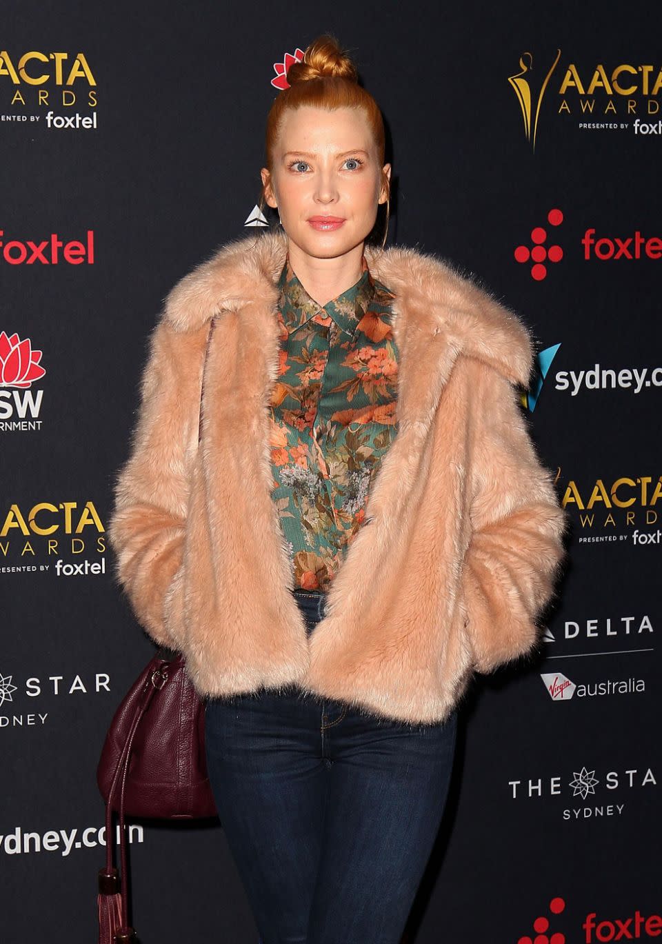 The 35-year-old star teamed her fitted denim trousers with a bright printed blouse, and a statement faux-fur jacket was layered over it. Source: Getty