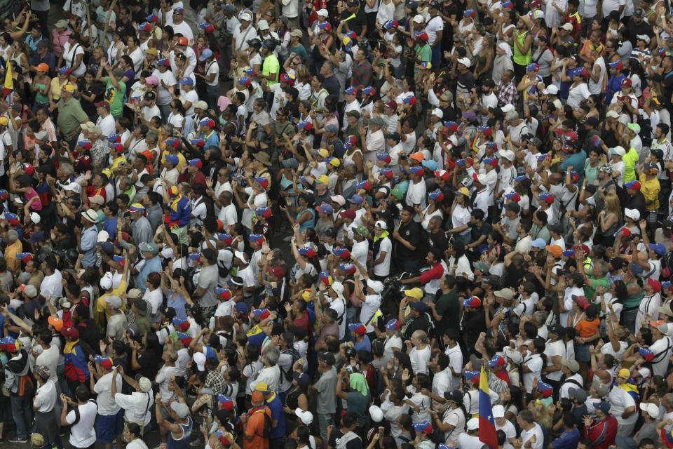 Supporters of Venezuela's National Assembly leader Juan Guaido, who declared himself the country's interim president, wait for his arrival to a rally against the government of President Nicolas Maduro, in Caracas, Venezuela, Saturday, March 9, 2019.(AP Photo/Boris Vergara)