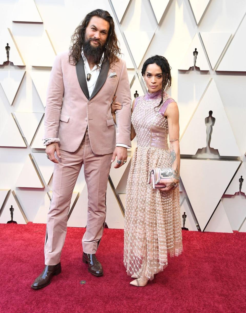 <p>A pink velvet Fendi tux—paying homage to Karl Lagerfeld, who passed away shortly before the 2019 Oscars—is a flex. Adding a pink velvet Fendi scrunchie to match? That's truly impressive.</p>