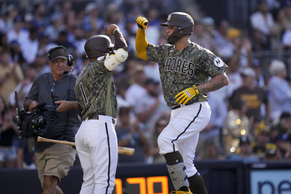 San Diego Padres' Gary Sanchez, right, celebrates with teammate Trent Grisham after hitting a home run during the third inning of a baseball game against the Los Angeles Dodgers, Sunday, Aug. 6, 2023, in San Diego. (AP Photo/Gregory Bull)