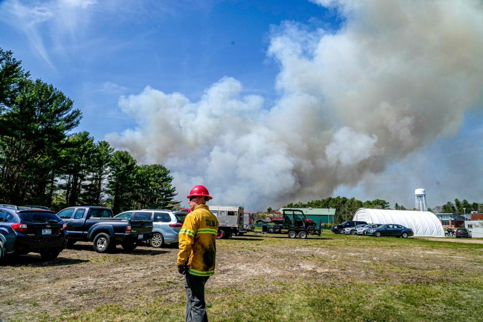 Plumes of smoke rise from the brush fire in Exeter last Friday.