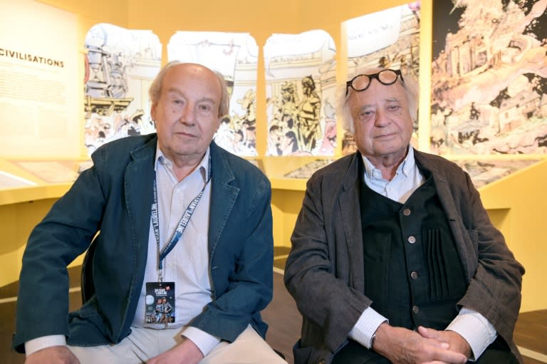 French comic strip creator Jean-Claude Mezieres (L) and French comics writer Pierre Christin sit at an exhibition dedicated to their science fiction comics series Valerian and Laureline in Paris