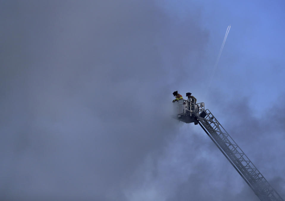 Firefighters battle a fire in downtown St. Paul, Minn., that has engulfed a building that was under construction on Tuesday, Aug. 4, 2020. There were no reports of injuries and there was no immediate word about the possible cause of the fire. (David Joles /Star Tribune via AP)