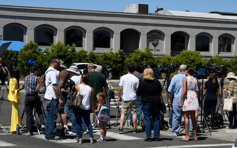 Neighbours and media members gather outside of the Chabad of Poway Synagogue - Credit: AP
