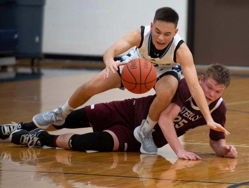 Cole Hostetler and Drew Flarida go for a loose ball.