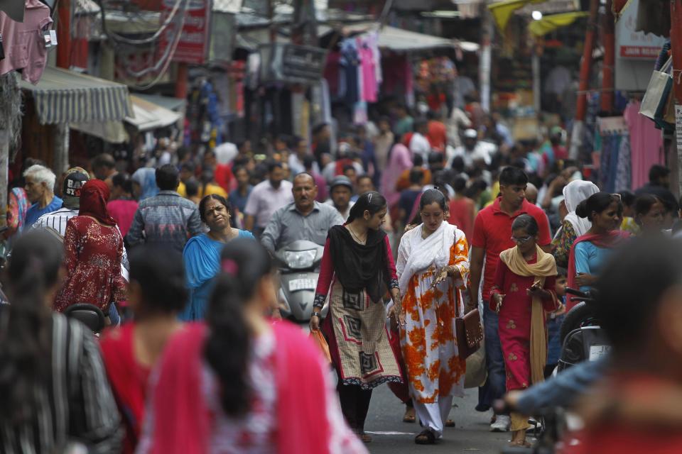 Muslim women return after getting fresh henna decorations on their hands on the eve of Eid al Adha, in Jammu, India, Sunday, Aug.11, 2019. Authorities in Indian-administered Kashmir said that they eased restrictions Sunday in most parts of Srinagar, the main city, ahead of an Islamic festival following India's decision to strip the region of its constitutional autonomy. There was no immediate independent confirmation of reports by authorities that people were visiting shopping areas for festival purchases as all communications and the internet remain cut off for a seventh day. (AP Photo/Channi Anand)