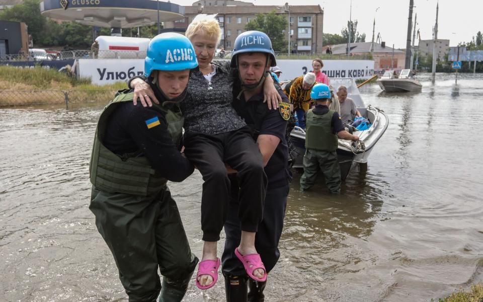 Rescuers evacuate residents from the floods in Kherson caused by the dam explosion - MYKOLA TYMCHENKO/EPA-EFE/Shutterstock