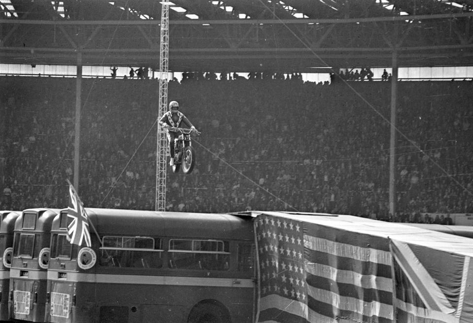 FILE - In this May 25, 1975, file photo, Evel Knievel approaches the landing ramp with his motorcycle during his unsuccessful effort to leap over 13 busses spanning 140-feet at 100 miles per hour in London. Evel Knievel’s son is on a collision course with the Walt Disney Co. and Pixar over a movie daredevil character named Duke Caboom. A federal trademark infringement lawsuit filed Tuesday, Sept. 22, 2020, in Las Vegas accuses the moviemaker of improperly basing the “Toy Story 4” character on Knievel, who died in 2007. (AP Photo, File)