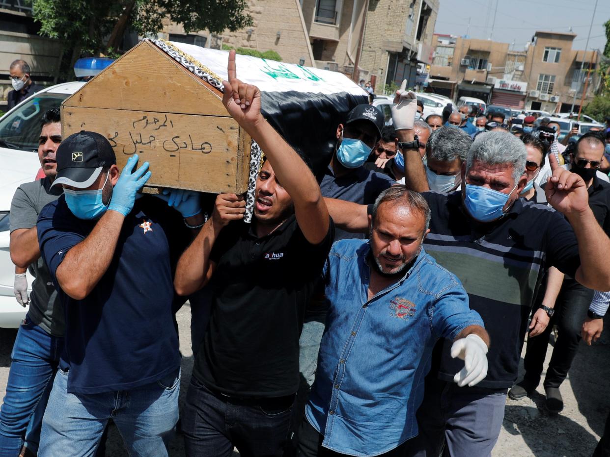 Mourners carry the coffin of former government advisor and political analyst Hisham al-Hashemi, who was killed by gunmen, during the funeral in Baghdad