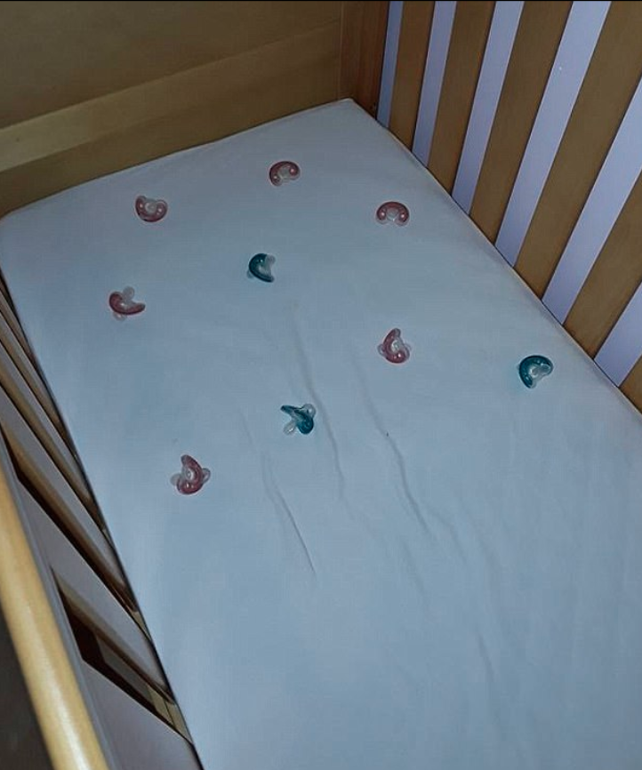 Laura fills her daughter's cot with dummies in case she needs one during the night. Photo: Facebook