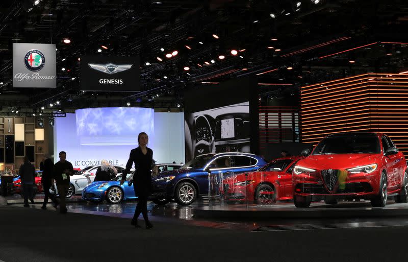 FILE PHOTO: Attendees walk past Alfa Romeo vehicles at the North American International Auto Show in Detroit, Michigan