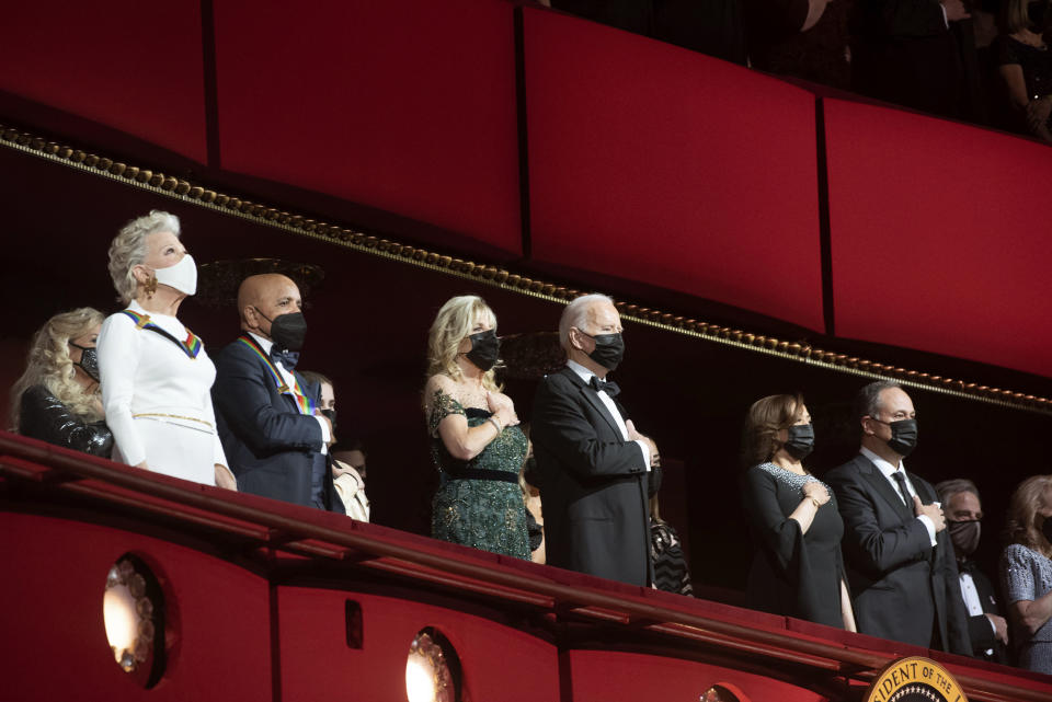 From left, 2021 Kennedy Center honorees Bette Midler, and Berry Gordy stand for the national anthem with first lady Jill Biden, President Joe Biden, Vice President Kamala Harris, second gentleman Doug Emhoff during the honors gala for the 44th Kennedy Center Honors at the John F. Kennedy Center for the Performing Arts in Washington, Sunday, Dec. 5, 2021. (AP Photo/Kevin Wolf)