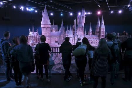 People look at a model of Hogwarts School of Witchcraft and Wizardry which is part of the Warner Bros "The Making of Harry Potter" studio tour in Leavesham, England, October 28, 2015. REUTERS/Russell Boyce/Files