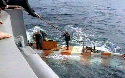 Russia rescue personnel return from a dive in a mini submarine to the Kursk on the sea bed - Credit: RU-RTR Russian Television via AP