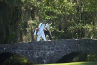 Tiger Woods walks over the Byron Nelson Bridge on the 13th hole during third round at the Masters golf tournament at Augusta National Golf Club Saturday, April 13, 2024, in Augusta, Ga. (AP Photo/Matt Slocum)