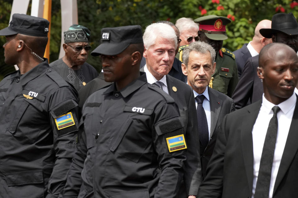 Former US President Bill Clinton, center left, and former President of France Nicolas Sarkozy, center right, leave after laying a wreath at the Kigali Genocide Memorial, in Kigali, Rwanda, Sunday, April 7, 2024. Rwandans are commemorating 30 years since the genocide in which an estimated 800,000 people were killed by government-backed extremists, shattering this small east African country that continues to grapple with the horrific legacy of the massacres. (AP Photo/Brian Inganga)