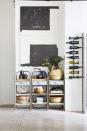 <p>No space, no problem. Use a wall unit like this one in a kitchen designed by <a href="https://leanneford.com/" rel="nofollow noopener" target="_blank" data-ylk="slk:Leanne Ford Interiors;elm:context_link;itc:0;sec:content-canvas" class="link ">Leanne Ford Interiors</a>. And there's a reason they bottles are organized horizontally: storing them like this keeps oxygen from slipping in through the cork. </p>